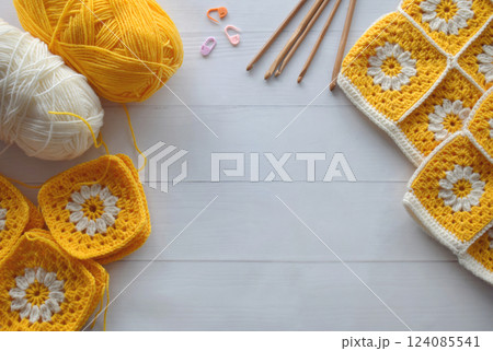 Crochet handmade granny square pattern, crocheting supplies, assorted colored wool yarn, hook, knitting crocheting Crochet handmade granny square pattern, crocheting supplies, assorted colored wool yarn, hook, knitting crocheting 124085541