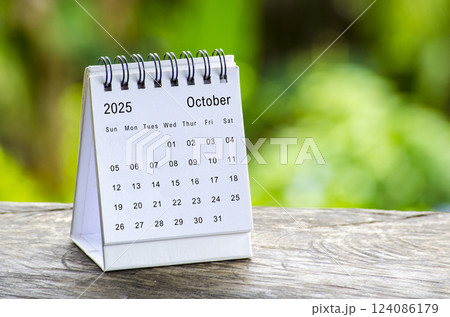 October 2025 white table calendar with outdoor background. Calendar concept October 2025 white table calendar with outdoor background. Calendar concept 124086179