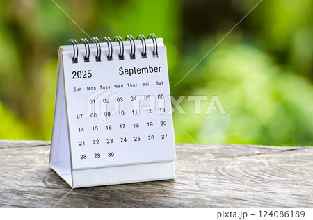 September 2025 white table calendar with outdoor background. Calendar concept 124086189