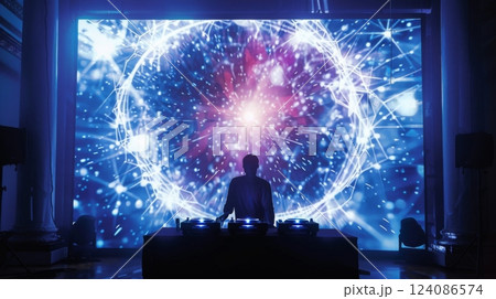 A DJ stands in silhouette in front of a large projection screen displaying a colorful and abstract design. 124086574