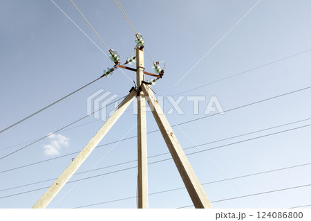 corner transmission tower of high voltage overhead power line. strain glass insulators, consists of assembly of suspension insulators, suspension strings, wires against the sky corner transmission tower of high voltage overhead power line. strain glass insulators, consists of assembly of suspension insulators, suspension strings, wires against the sky 124086800