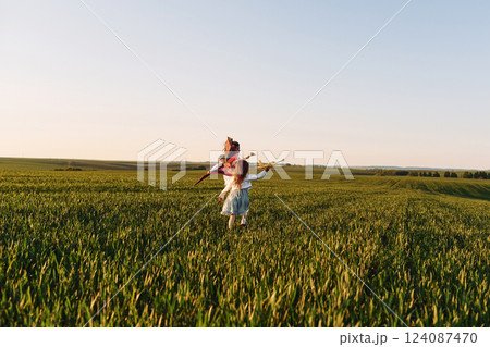 Two children have fun outdoors on the field at summer 124087470