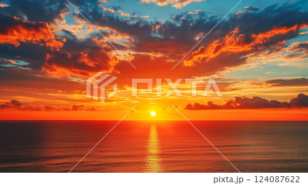 Breathtaking sunset over calm ocean waters with vibrant clouds and colors 124087622