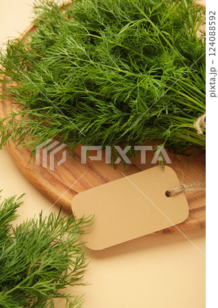 Bunch of dill with inscription on beige background. Top view. Food for vegetarians 124088592