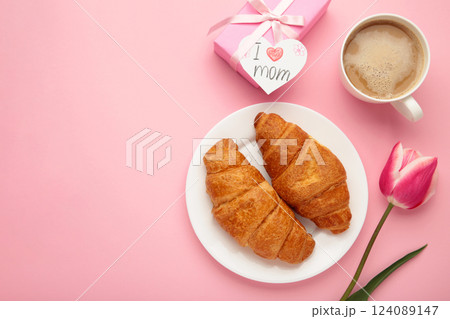 Happy mother's day, beautiful breakfast, lunch with cup of coffee, fresh croissants, tulip and gift. Spring holiday, family relations. 124089147