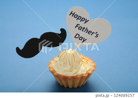Father's day message with a cupcake with a moustache on dark blue background. 124089157