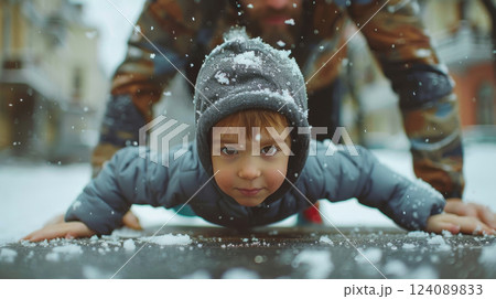 Brave Kid Doing Push-Ups in Snowy Weather for Year-Round Fitness Brave Kid Doing Push-Ups in Snowy Weather for Year-Round Fitness 124089833