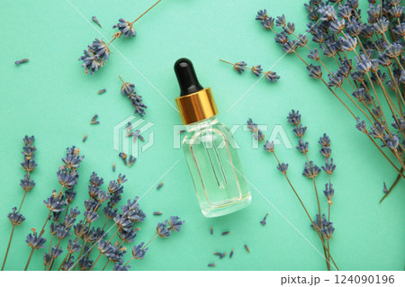 Flat lay composition with lavender flowers and lavender oil on mint background 124090196