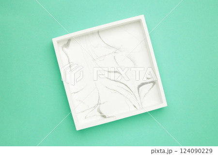 Ceramic square tray on a mint background Ceramic square tray on a mint background 124090229