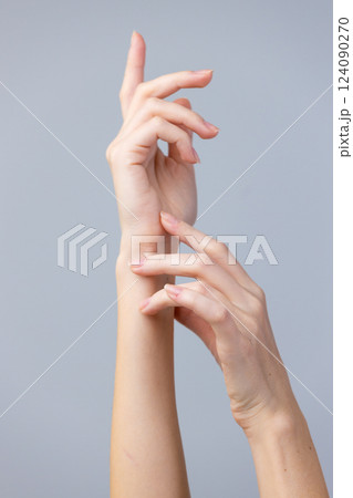Elegant Gesture of Delicate Hands Displaying Artistry and Grace Against a Minimalistic Background for Creative Aesthetic Appreciation and Design Inspiration 124090270