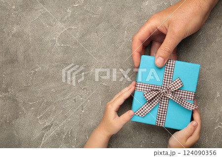 Father's day gift with daughter or son holding dad's hands giving present box to tell I love you dad, I am so thankful and happy fathers day. Father's day gift with daughter or son holding dad's hands giving present box to tell I love you dad, I am so thankful and happy fathers day. 124090356