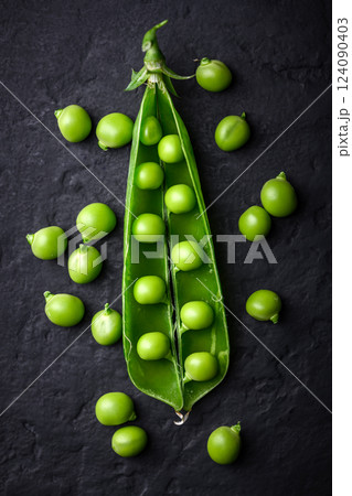 Open pod of green sugar snap pea with kernels Open pod of green sugar snap pea with kernels 124090403