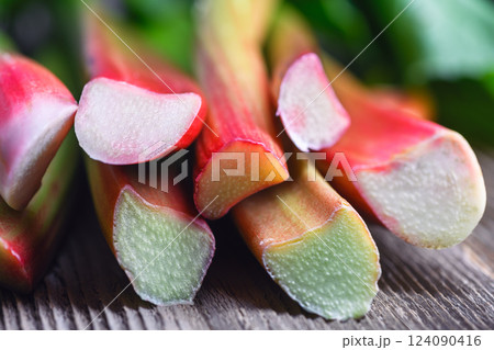 Macro shot of ripe rhubarb stalks on a wooden table 124090416