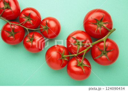 Flat lay composition with bunch of tomatoes on mint background. Space for text 124090434
