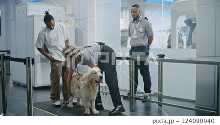 Man with Pet During Screening Procedures in Airport Terminal: Female TSA Officer Scanning Dog 124090940
