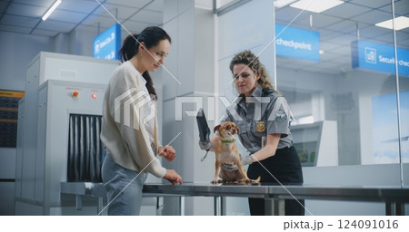 Female TSA Officer Inspects Dog Using Metal Detector Scanner, Places Puppy in Carrier 124091016