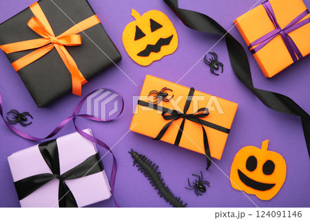 Halloween flat lay with orange, black and purple seasonal paper craft gift boxes on violet background 124091146