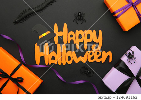 Inscription Happy Halloween with gift boxes, spiders on violet background. Inscription Happy Halloween with gift boxes, spiders on violet background. 124091162