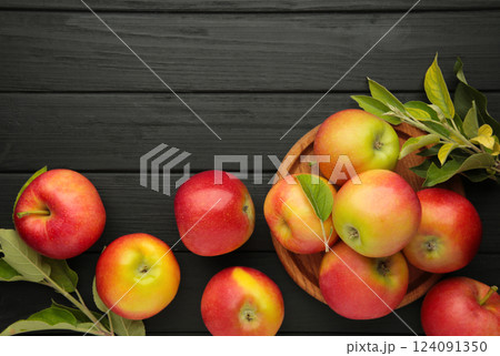 Group of red apples with their leaves on black background. Space for text 124091350