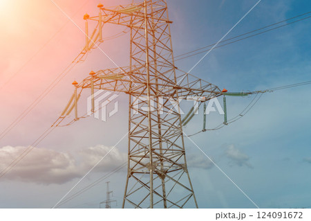 High voltage towers with sky background. Power line support with wires for electricity transmission. High voltage grid tower with wire cable at distribution station. Energy industry, energy saving 124091672