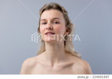 A Portrait of Natural Beauty: Capturing the Essence of a Woman with Soft Features and a Confident Expression Under Dim Lighting Against a Light Gray Background A Portrait of Natural Beauty: Capturing the Essence of a Woman with Soft Features and a Confident Expression Under Dim Lighting Against a Light Gray Background 124091897