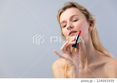 Captivating Portrait of a Woman Showcasing a Bold Pink Lipstick in an Elegant and Minimalist Setting, Perfect for Fashion and Beauty Inspiration 124091939