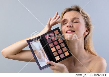 Captivating Beauty: A Model Gracefully Showcases a Stunning Makeup Palette While Radiating Confidence and Joy with Her Elegant Pose and Expressive Facial Features 124092011