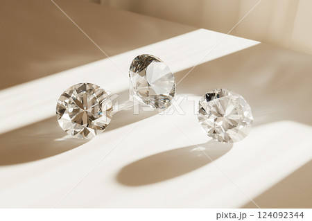 Elegant Commercial Shot of Three White Diamonds on a Light Table 124092344