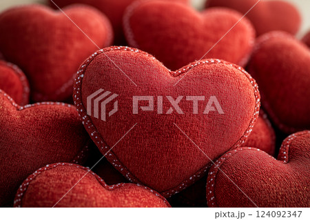 Pile of Red Fabric Heart-Shaped Pillows for Valentine's Day Background or Decoration 124092347