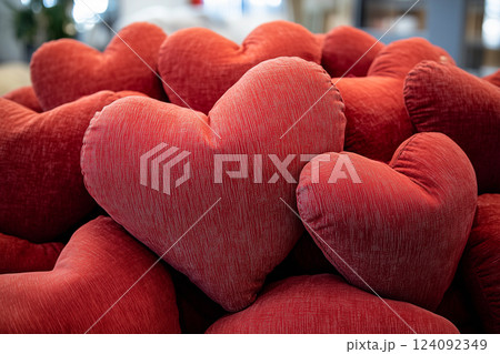 Pile of Red Fabric Heart-Shaped Pillows for Valentine's Day Celebration Background 124092349