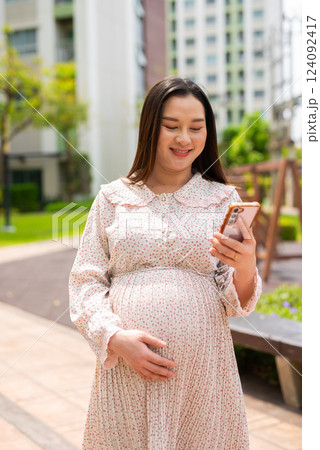 Pregnant woman portrait in park 124092417