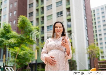 Pregnant woman portrait in park 124092418