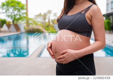 Pregnant fitness woman at swimming pool Pregnant fitness woman at swimming pool 124092439