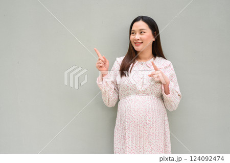 Pregnant woman portrait against plain wall Pregnant woman portrait against plain wall 124092474