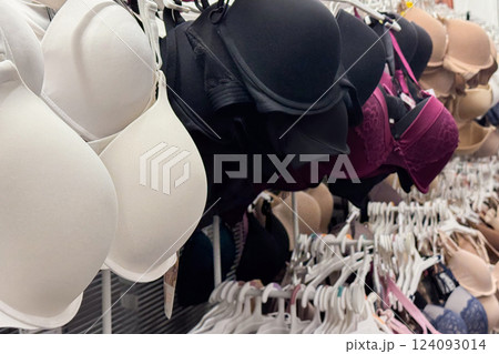 a retail store's lingerie section displaying bras in various colors and styles on racks a retail store's lingerie section displaying bras in various colors and styles on racks 124093014
