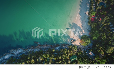 Palm trees cast shadows on the pristine white sand beach turquoise waters of Bottle Beach, Koh Phangan, Thailand, a stunning aerial view showcasing the tropical paradise. Travel, tourism, holiday 124093375