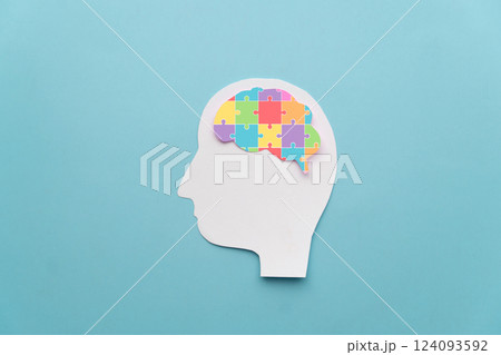 World autism awareness day concept. Human head with colorful jigsaw puzzle brain shape on blue background. Creative idea for Autism Spectrum Disorder (ASD). World autism awareness day concept. Human head with colorful jigsaw puzzle brain shape on blue background. Creative idea for Autism Spectrum Disorder (ASD). 124093592