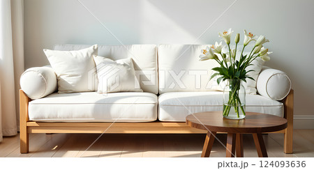 Simple living room with white sofa, decorations, and perfect everyday lighting. 124093636