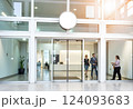 Blank white round signage mockup on the store glass sliding doors entrance, 3d rendering. Commercial building automatic entry, banner mock up. Closed transparent business center facade, front view. 124093683