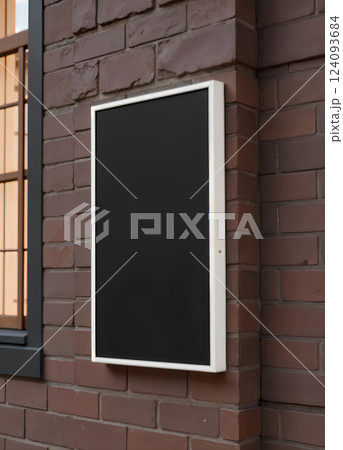 Blank black glass rectangular poster mock up brick wall mounted. 124093684