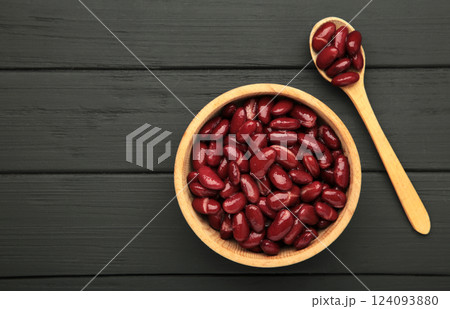 Red beans in wooden bowl and spoon on black background. 124093880