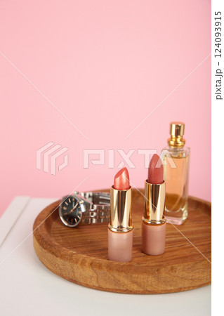 Cosmetic set on light dressing table on pink background Cosmetic set on light dressing table on pink background 124093915