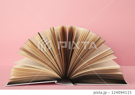 Open book on pink background. Space for text Open book on pink background. Space for text 124094115
