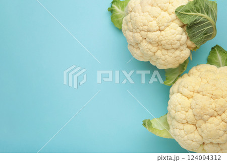 Fresh organic cauliflower on blue background. Flat lay Fresh organic cauliflower on blue background. Flat lay 124094312
