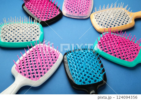 Set of hairbrushes on dark blue background. Flat lay Set of hairbrushes on dark blue background. Flat lay 124094356