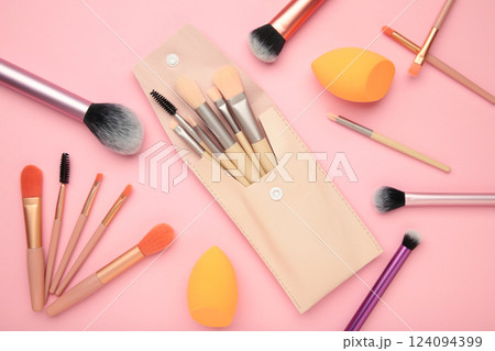 Professional female cosmetics brushes for makeup and eyelash brush on pink background. Cosmetics concept, make up concept Professional female cosmetics brushes for makeup and eyelash brush on pink background. Cosmetics concept, make up concept 124094399