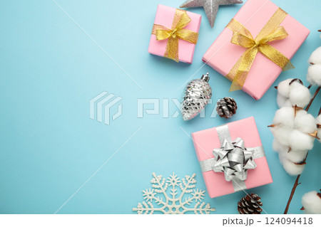 Christmas composition. Pink gifts, silver decorations on blue background. New year concept. Christmas composition. Pink gifts, silver decorations on blue background. New year concept. 124094418