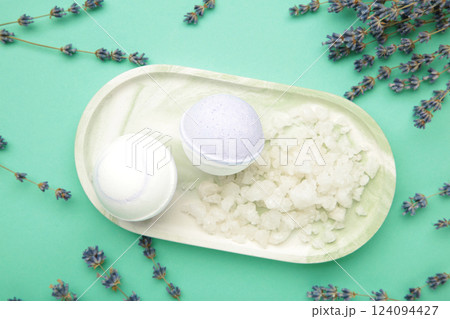 Natural cosmetics. Handmade lavender bath bombs and lavender flowers on board on mint background. Natural cosmetics. Handmade lavender bath bombs and lavender flowers on board on mint background. 124094427