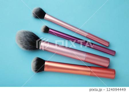 Make up brush sets arranged on blue background. Cosmetics products. 124094449