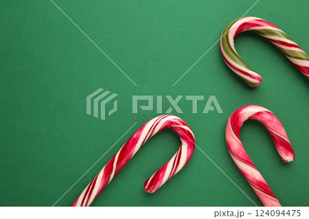 Christmas candy cane on green background. Top view Christmas candy cane on green background. Top view 124094475